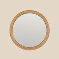Ornate round wall mirror with intricate gold detailing.
