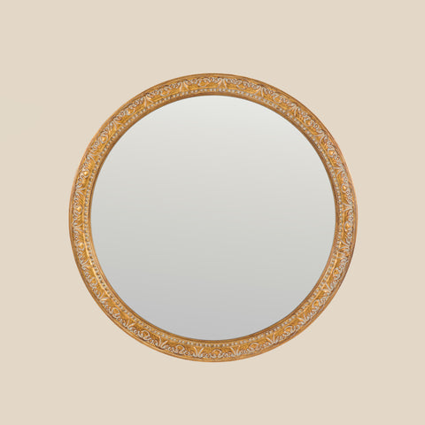 Ornate round wall mirror with intricate gold detailing.