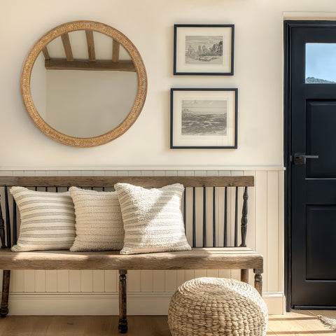 Ornate round wall mirror with intricate gold detailing, styled in a welcoming interior to bring warmth and timeless elegance.
