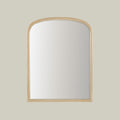 Arched wall mirror in a softly aged metallic finish.
