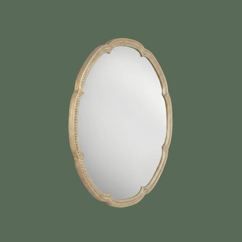 Round scalloped wall mirror with ornate champagne gold frame and decorative beaded detailing, at an angle